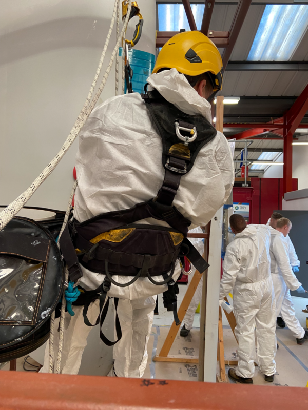 wind turbine technician training on a practice turbine blade