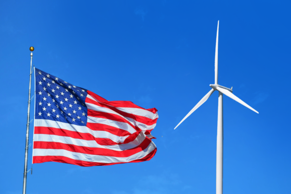 Photo of American flag and wind turbine